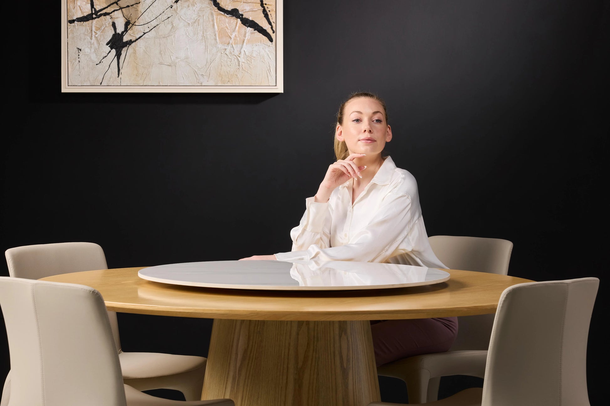 Hedda Light Wood Round Dining Table - Female Model Glance