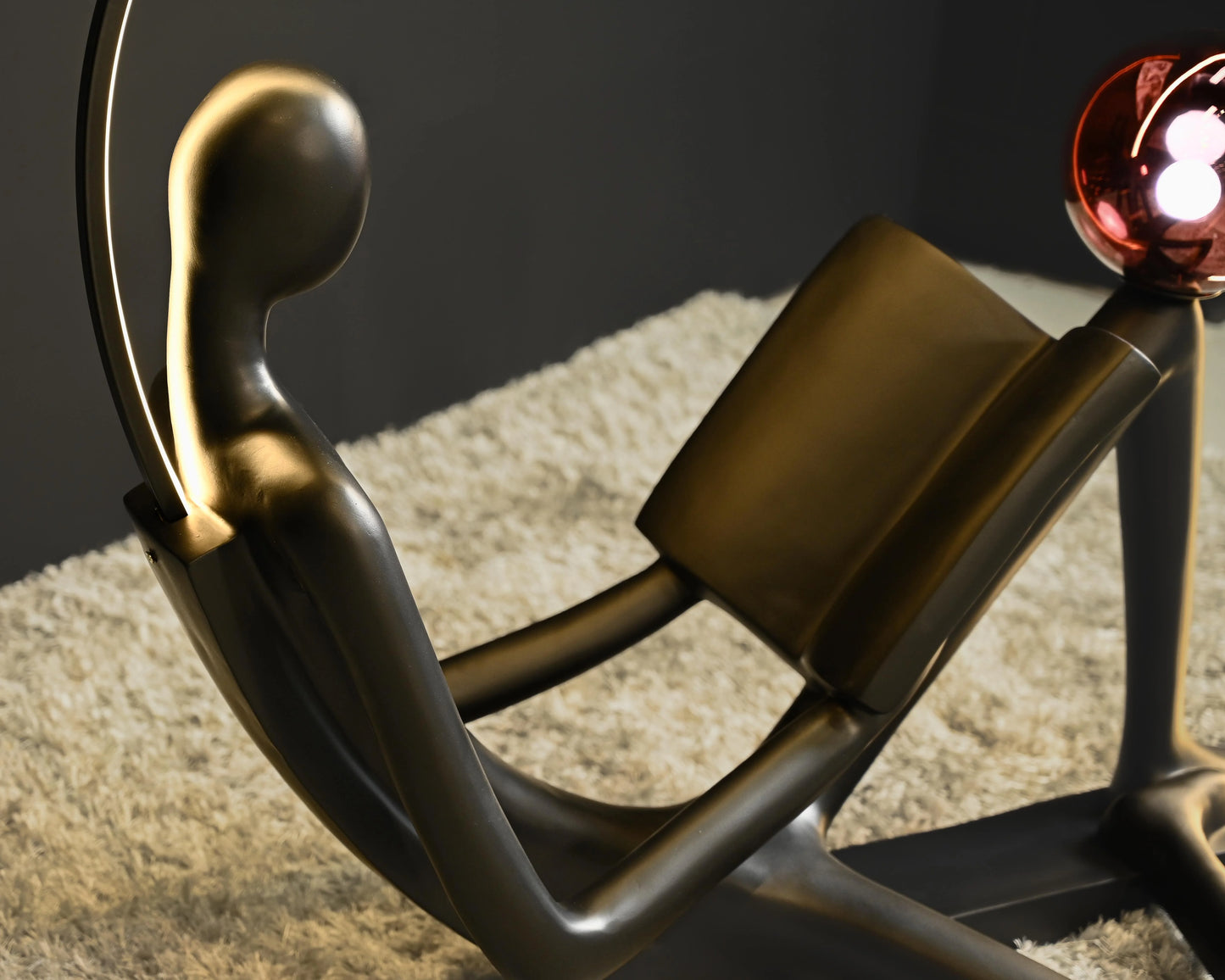 Love floor lamp close-up on Black Figure Reading Book