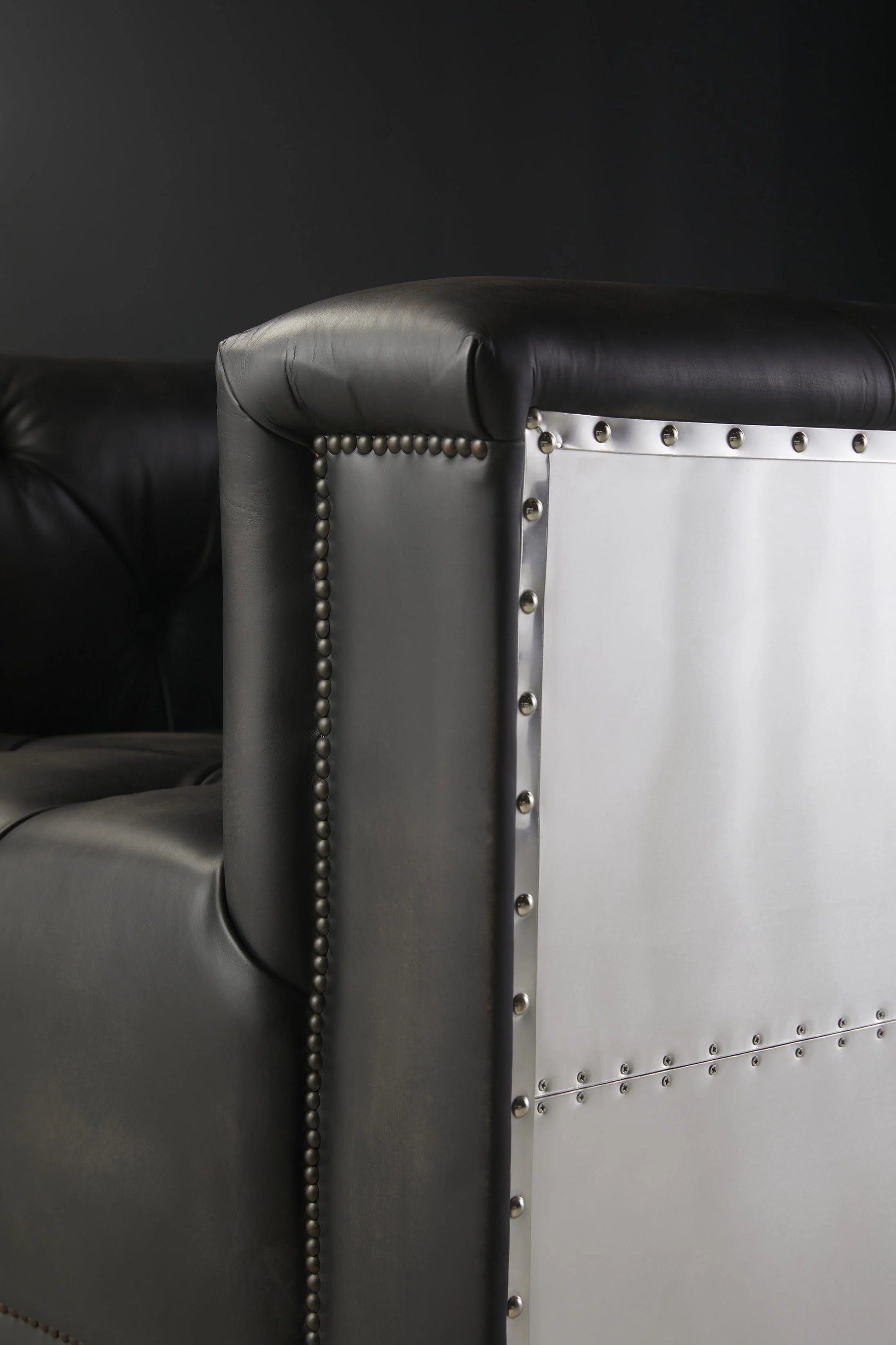 Metallic Accent Detail on Black Vintage Sofa Side View